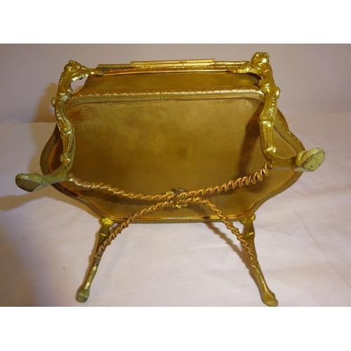 91 - A gilt metal jewellery box raised on four scroll legs.