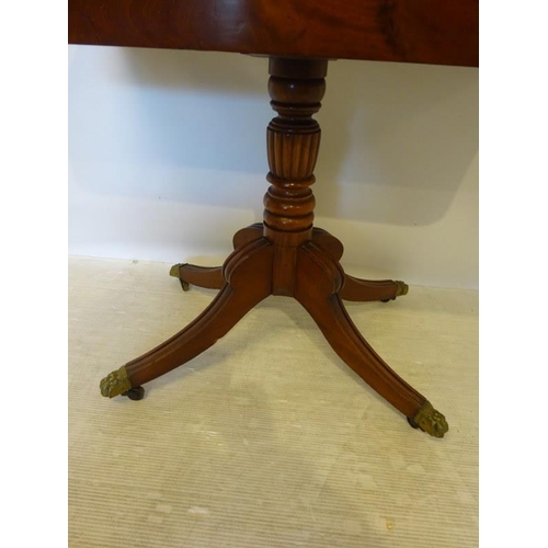 140 - 19th century mahogany fold over tea table raised on centre column and reeded splay feet. W. 90cm, D.... 