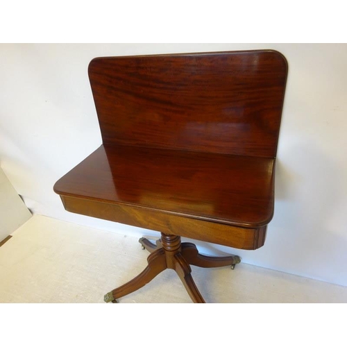 140 - 19th century mahogany fold over tea table raised on centre column and reeded splay feet. W. 90cm, D.... 