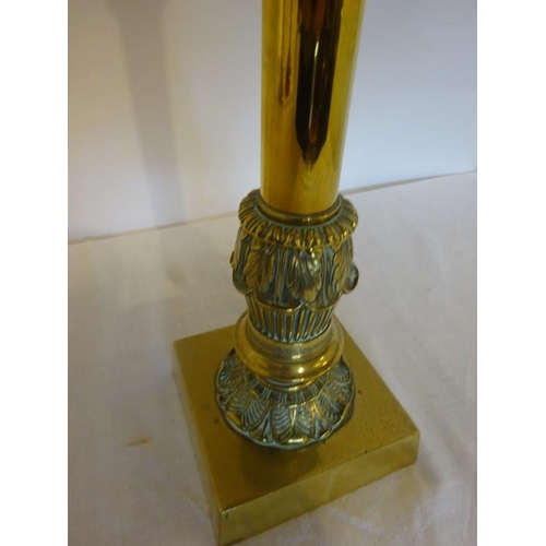 143 - Antique brass column oil lamp with red glass bowl and football shade.