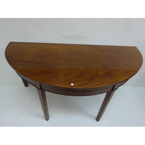 147 - Georgian mahogany demi lune side table raised on square legs. W. 146cm, D.  67cm, H. 70cm approx.