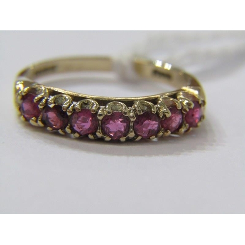 194 - 9ct gold seven stone ruby half eternity ring. Size O.