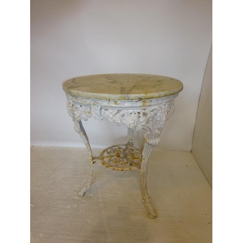 201 - Antique cast iron garden table with marble top. Diameter 64cm approx.