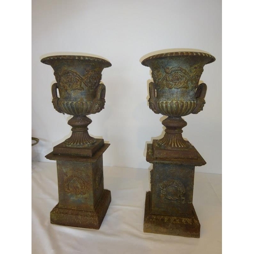 203 - A rare pair of antique cast iron garden urns and bases. Overall H. 70cm, diameter 28cm approx.