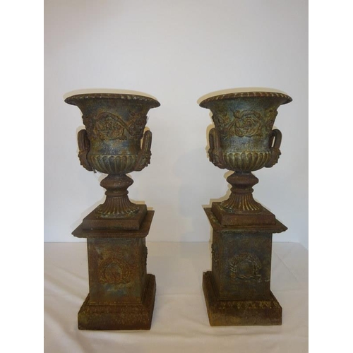 203 - A rare pair of antique cast iron garden urns and bases. Overall H. 70cm, diameter 28cm approx.