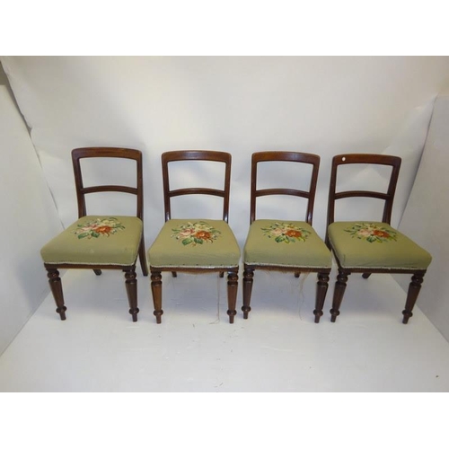 239 - A set of 4 19th century mahogany dining chairs with needlework seats.