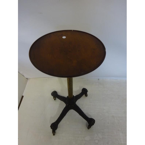 252 - Victorian circular mahogany occasional table on adjustable brass column and cast iron base.