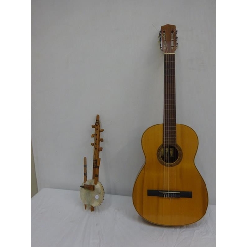 277 - A guitar, a small African musical instrument and an Italian harmonica. (3)