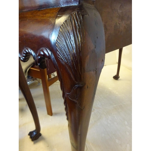 280 - An Irish Edwardian mahogany side table, the rectangular top over shaped freized with carved head dec... 