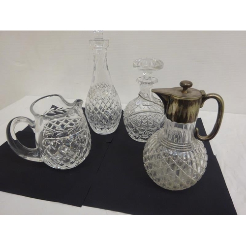 315 - A lot of Waterford and other glass ware - two decanters, one water jug and a plated top claret jug. ... 