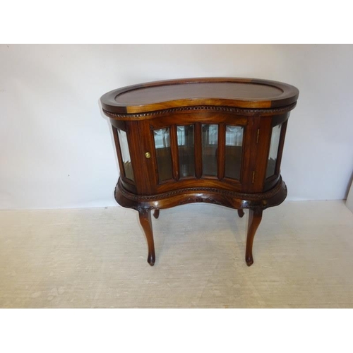 320 - A kidney shaped drinks cabinet with removable tray top.