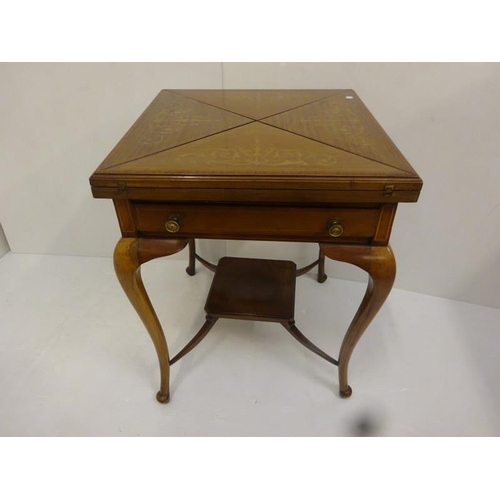 338 - Edwardian inlaid mahogany envelope card table fitted with a drawer and raised on curved legs.