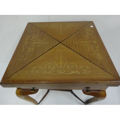 338 - Edwardian inlaid mahogany envelope card table fitted with a drawer and raised on curved legs.