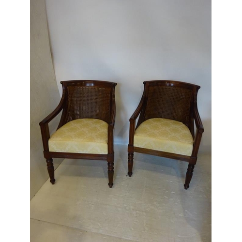 68 - A pair of mahogany framed drawing room easy chairs with bergere backs and drop in seats.