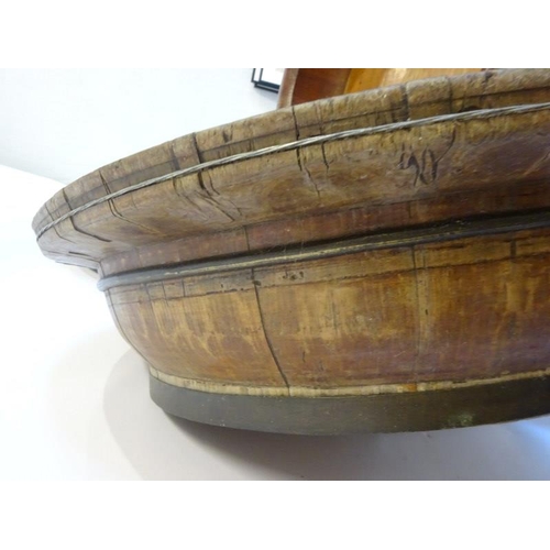 70 - Four large old brass banded timber bowls, one needing attention. Diameter 80cm approx.