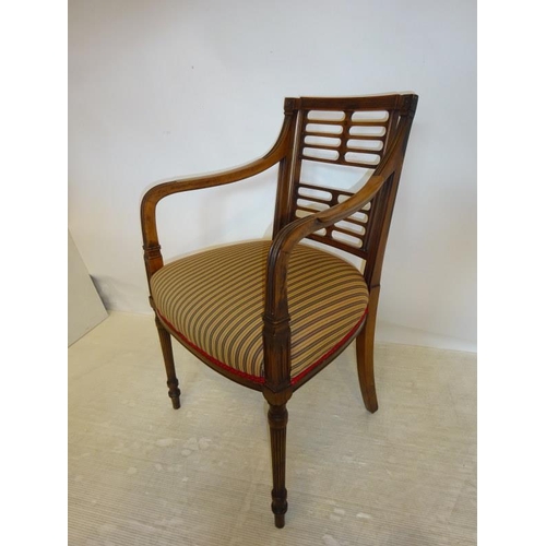 76 - Antique mahogany open arm easy chair raised on fluted legs.