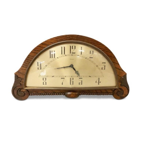 91 - Art Deco mantel clock in carved oak case.