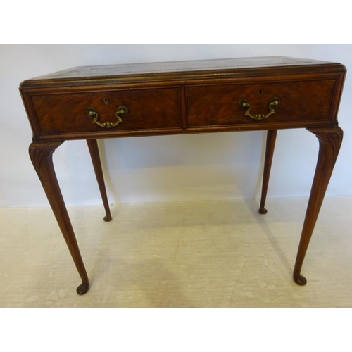 95 - An Edwardian walnut ladies writing table, the rectangular top with leather inset, fitted with two dr... 