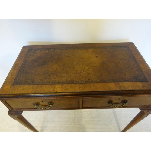 95 - An Edwardian walnut ladies writing table, the rectangular top with leather inset, fitted with two dr... 