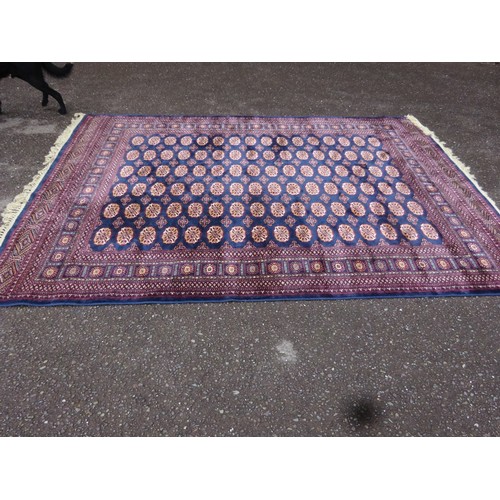 301 - A large Bokhara wool/silk drawing room rug. 305cm x 198cm approx.