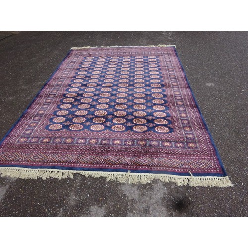 301 - A large Bokhara wool/silk drawing room rug. 305cm x 198cm approx.