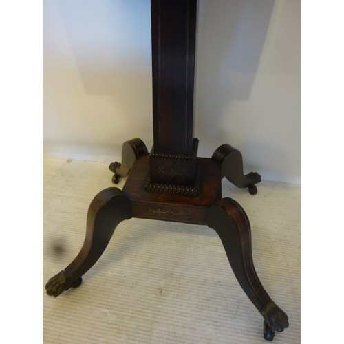 137 - A Regency rosewood and brass inlaid teapoy having a fitted interior and raised on splay legs with br... 