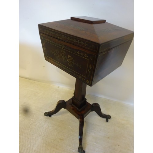 137 - A Regency rosewood and brass inlaid teapoy having a fitted interior and raised on splay legs with br... 