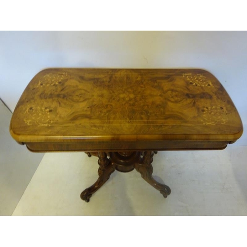 106 - Victorian inlaid and figured walnut card table, the folding top raised on four columns with carved s... 