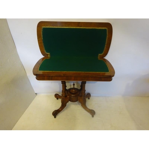 106 - Victorian inlaid and figured walnut card table, the folding top raised on four columns with carved s... 