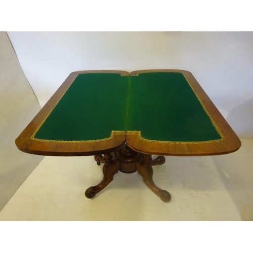 106 - Victorian inlaid and figured walnut card table, the folding top raised on four columns with carved s... 