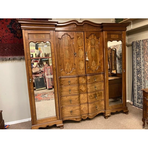 113 - An excellent quality Edwardian inlaid mahogany wardrobe having mirror and cupboard doors, shaped dra... 