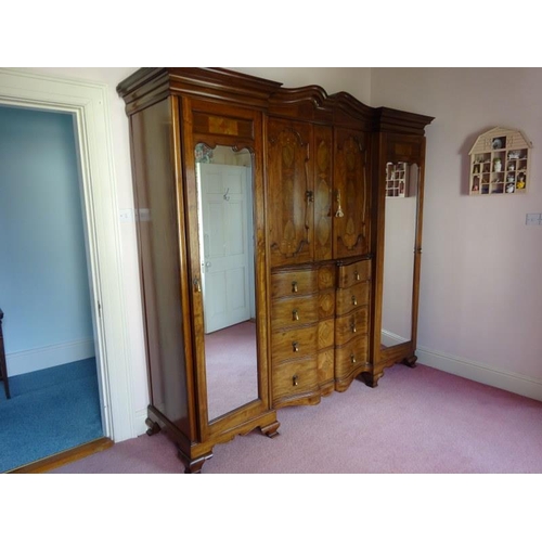 113 - An excellent quality Edwardian inlaid mahogany wardrobe having mirror and cupboard doors, shaped dra... 