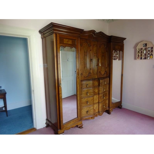 113 - An excellent quality Edwardian inlaid mahogany wardrobe having mirror and cupboard doors, shaped dra... 