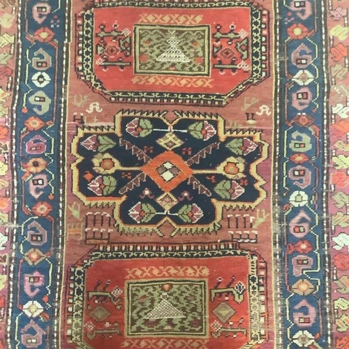 114 - A good Persian runner rug. 340cm x 104cm.