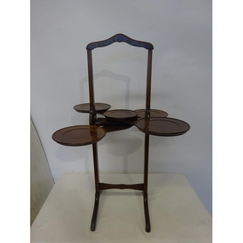 132 - A good Edwardian mahogany folding and adjustable cake stand.