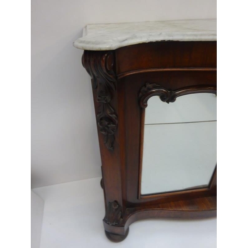 134 - Victorian rosewood side cabinet having serpentine shaped marble top over mirror doors on shaped base... 