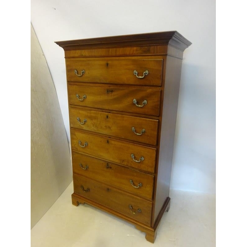 140 - A Georgian mahogany tall boy chest of 6 graduated drawers having brass drop handles and raised on br... 