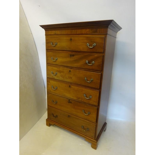 140 - A Georgian mahogany tall boy chest of 6 graduated drawers having brass drop handles and raised on br... 