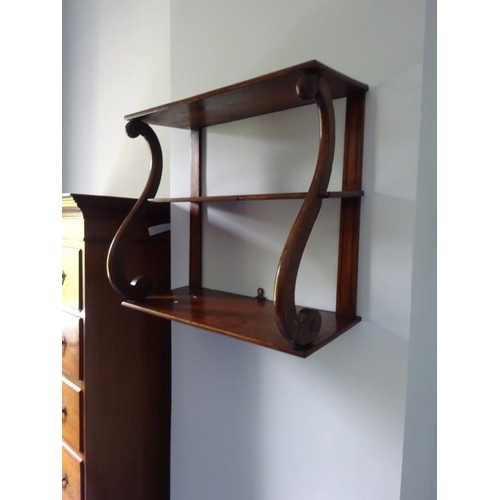 145 - A 19th century mahogany hanging shelves on scroll supports. Overall height 47cm, W. 54cm, D. 23cm. a... 