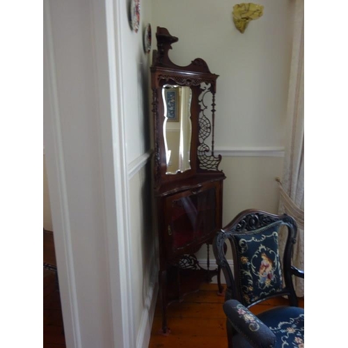 147 - An Edwardian carved mahogany and mirror back corner cabinet. H. 200cm approx.