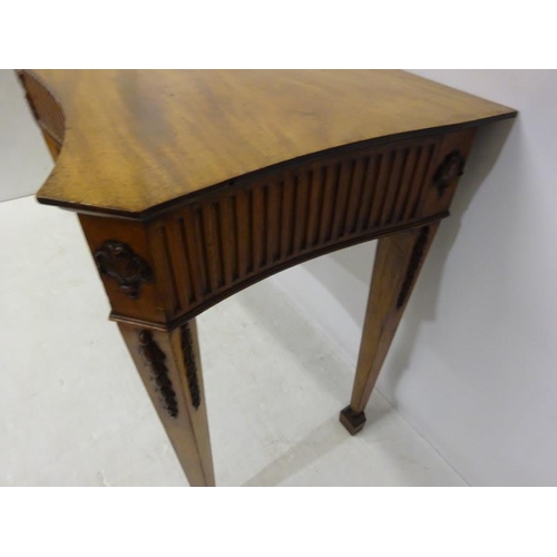 150 - A fine antique mahogany side table, the shaped top and sides having fluted and urn decoration raised... 