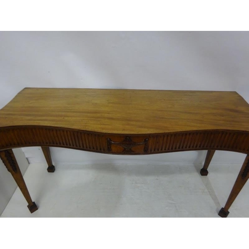 150 - A fine antique mahogany side table, the shaped top and sides having fluted and urn decoration raised... 