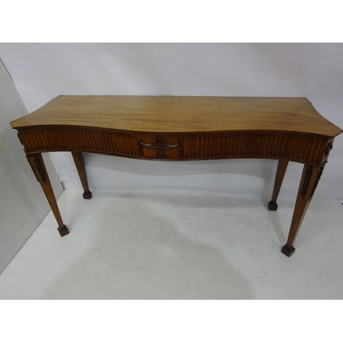 150 - A fine antique mahogany side table, the shaped top and sides having fluted and urn decoration raised... 