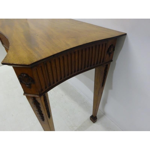 150 - A fine antique mahogany side table, the shaped top and sides having fluted and urn decoration raised... 