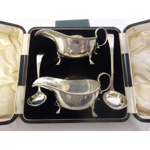 161 - A pair of cased silver sauce boats with one silver ladle and one plated ladle. Sheffield 1951.