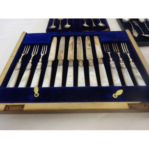 183 - Six mother of pearl handle and plated fruit knives and forks together with a cased set of six decora... 