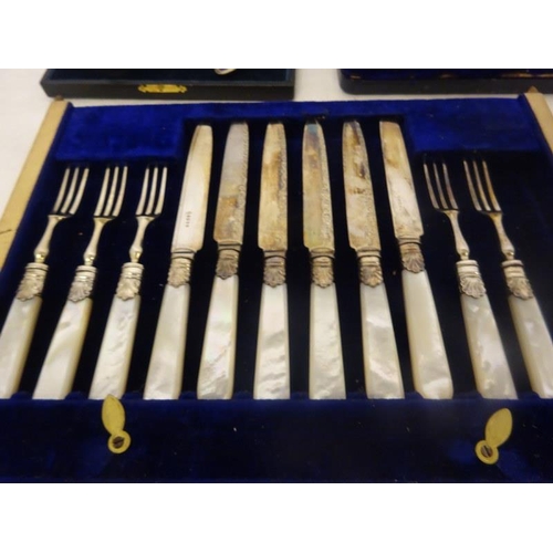 183 - Six mother of pearl handle and plated fruit knives and forks together with a cased set of six decora... 