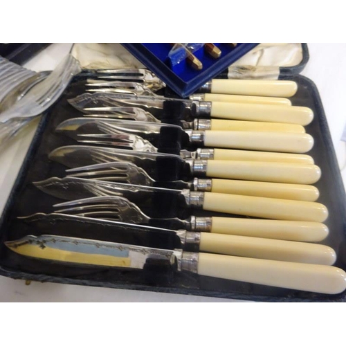 186 - A quantity of plated cased sets to include fish servers, fish knives and forks, etc.  (7)