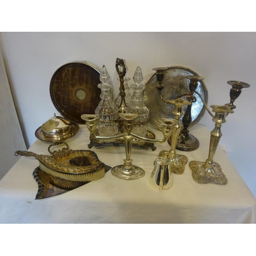 187 - A mixed lot of plated ware to include a decanter set, candleabra, table brush and crumb tray, etc.