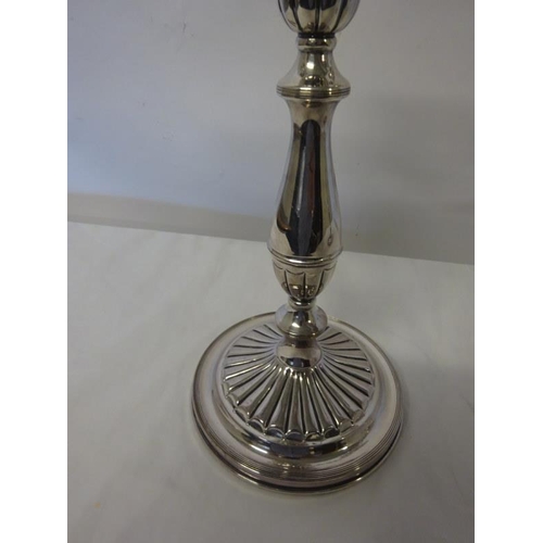 191 - A pair of silver plated table candleabra raised on circular bases with fluted decoration.